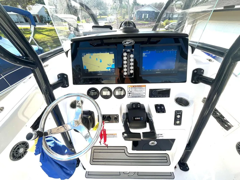 Slide: The Image of 2023 Sea Fox 268 Commander boat dashboard with navigation screens and controls. - 24