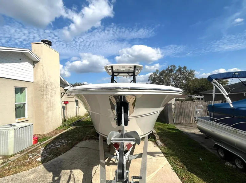 Slide: The Image of 2023 Sea Fox 268 Commander boat on trailer, parked in residential driveway under blue sky. - 3