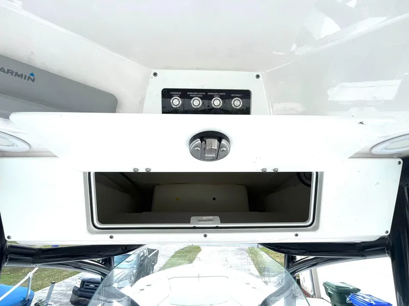 Slide: The Image of 2023 Sea Fox 268 Commander boat console with open storage compartment and control panel. - 32
