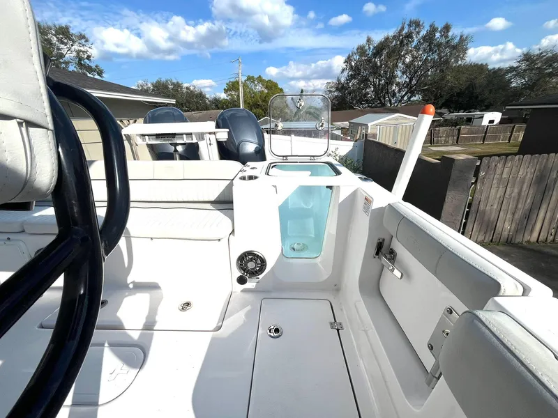Slide: The Image of 2023 Sea Fox 268 Commander boat interior with seating and storage, under a clear blue sky. - 43