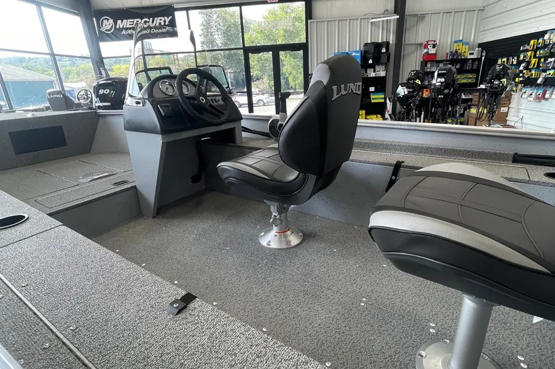 Slide: The Image of 2025 Lund 1400 Fury SS boat interior with steering console and seating. - 3
