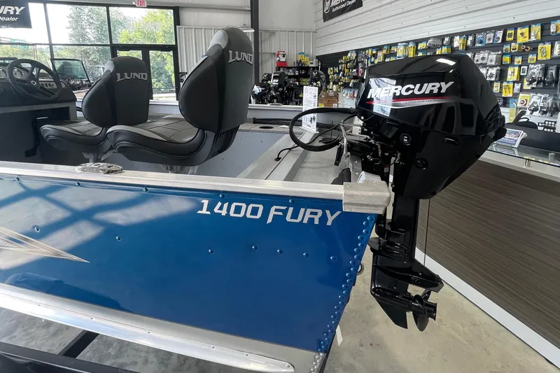 Slide: The Image of 2025 Lund 1400 Fury SS boat with Mercury outboard motor in showroom. - 4