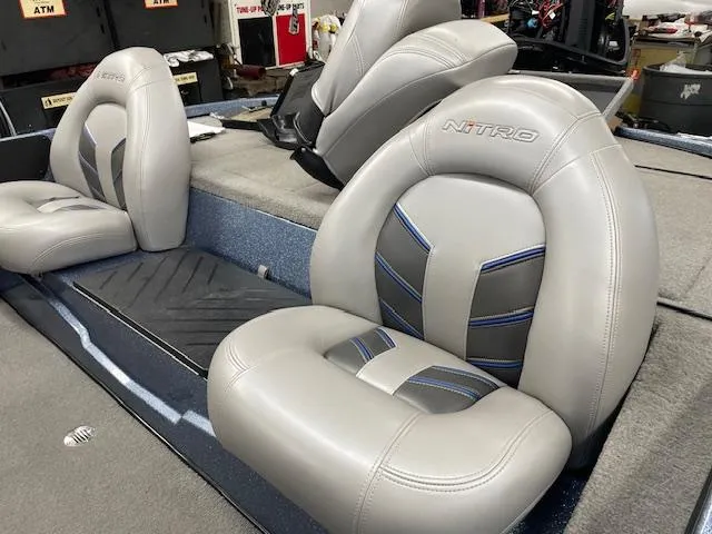 Slide: The Image of 2023 Nitro Z17 boat seats with gray upholstery and blue accents. - 6