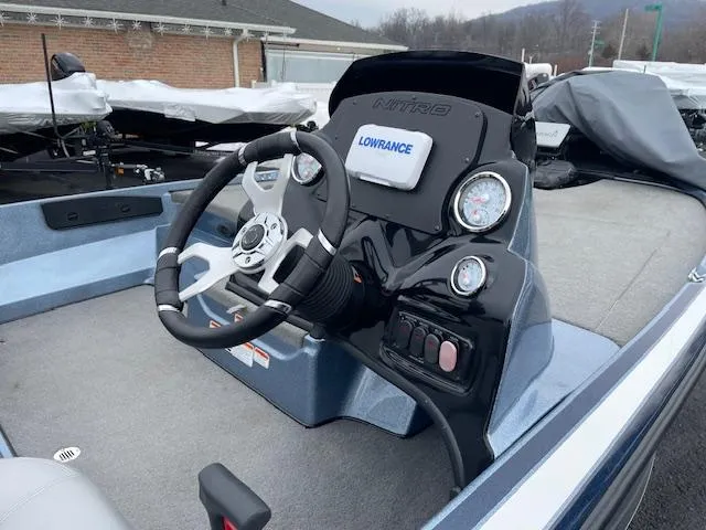 Slide: The Image of 2023 Nitro Z17 boat dashboard with steering wheel and Lowrance electronics. - 8