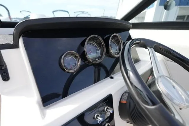 Slide: The Image of Dashboard of 2023 Sea Ray SPX 210 boat with gauges and steering wheel. - 11
