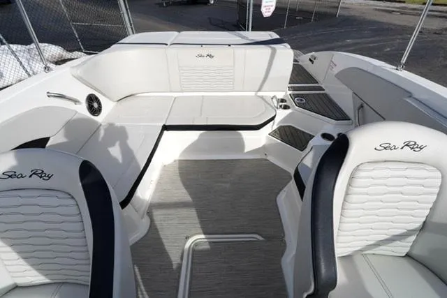 Slide: The Image of 2023 Sea Ray SPX 210 boat interior with white seating and modern design. - 12