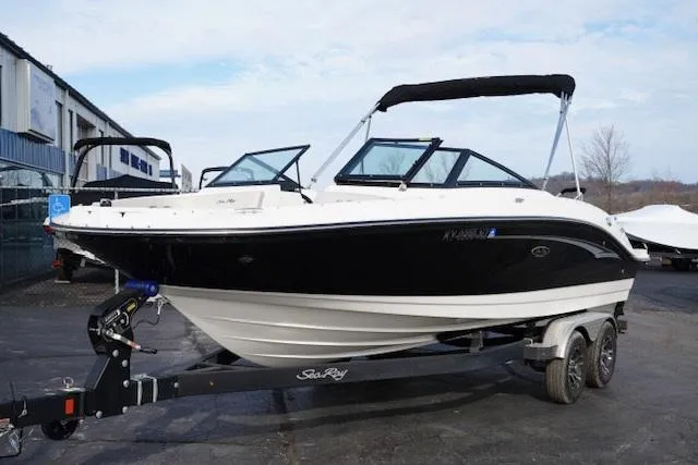 Slide: The Image of 2023 Sea Ray SPX 210 boat on trailer, black and white design, parked outdoors. - 4