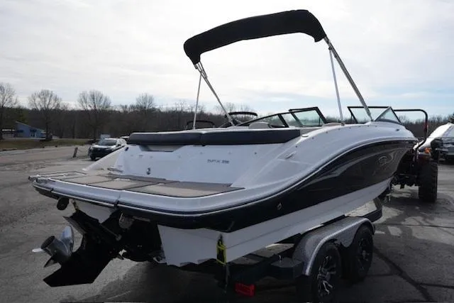 Slide: The Image of 2023 Sea Ray SPX 210 boat on trailer, black and white design, outdoor setting. - 5