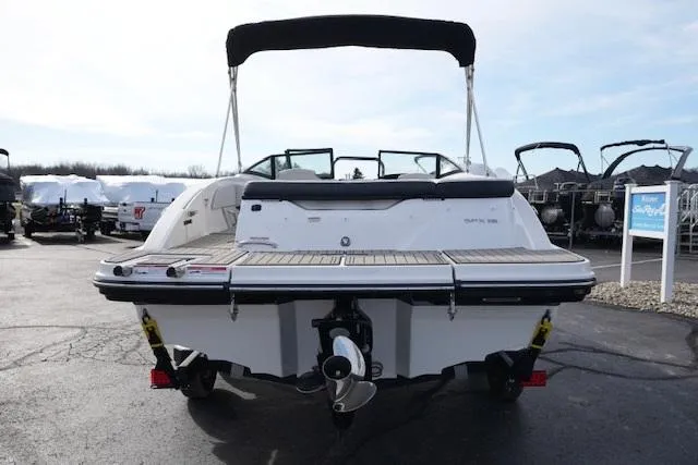 Slide: The Image of 2023 Sea Ray SPX 210 boat, rear view, in a marina setting. - 6