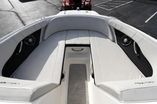 Slide: The Image of 2023 Sea Ray SPX 210 boat interior with white seating and black speaker accents. - 7