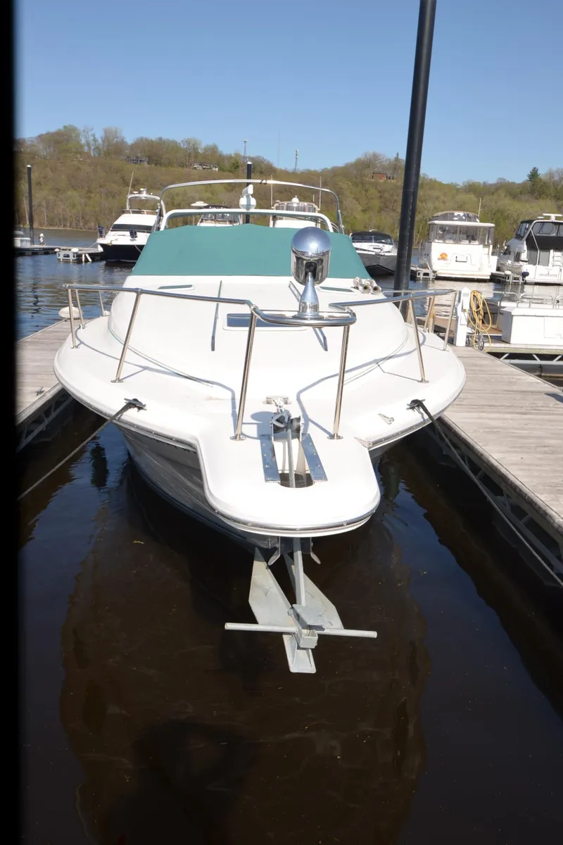 Slide: The Image of 1994 Sea Ray 330 Sundancer docked at a marina, front view. - 12
