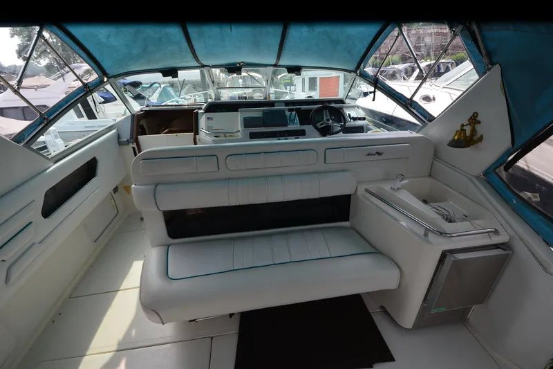 Slide: The Image of Interior of a 1994 Sea Ray 330 Sundancer boat with seating and helm. - 13