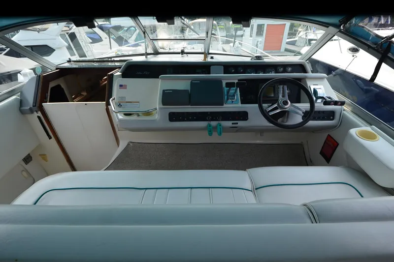 Slide: The Image of Cockpit of 1994 Sea Ray 330 Sundancer with steering wheel and control panel. - 15