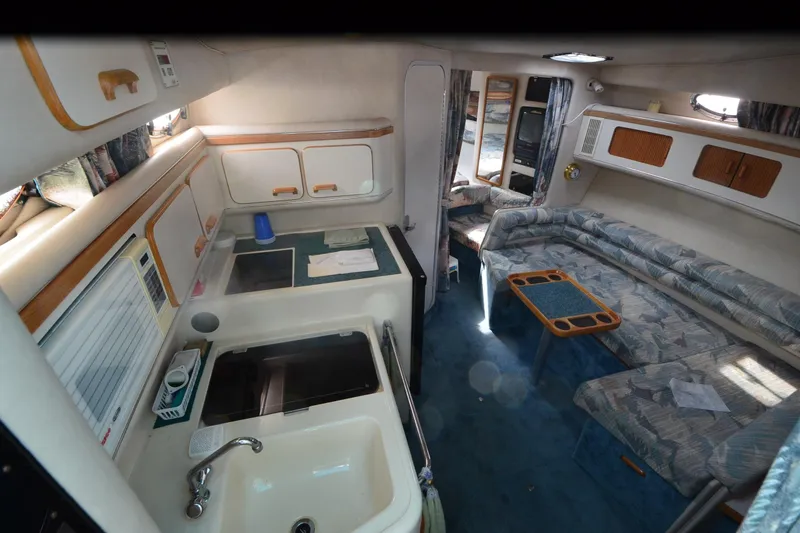 Slide: The Image of Interior of a 1994 Sea Ray 330 Sundancer yacht with kitchen and seating area. - 18
