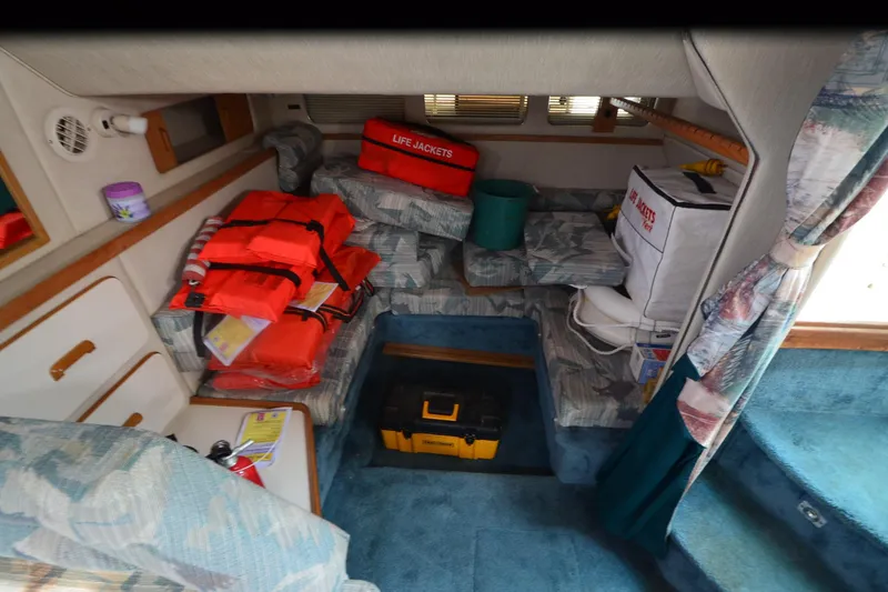 Slide: The Image of Interior of 1994 Sea Ray 330 Sundancer with life jackets and storage compartments. - 19