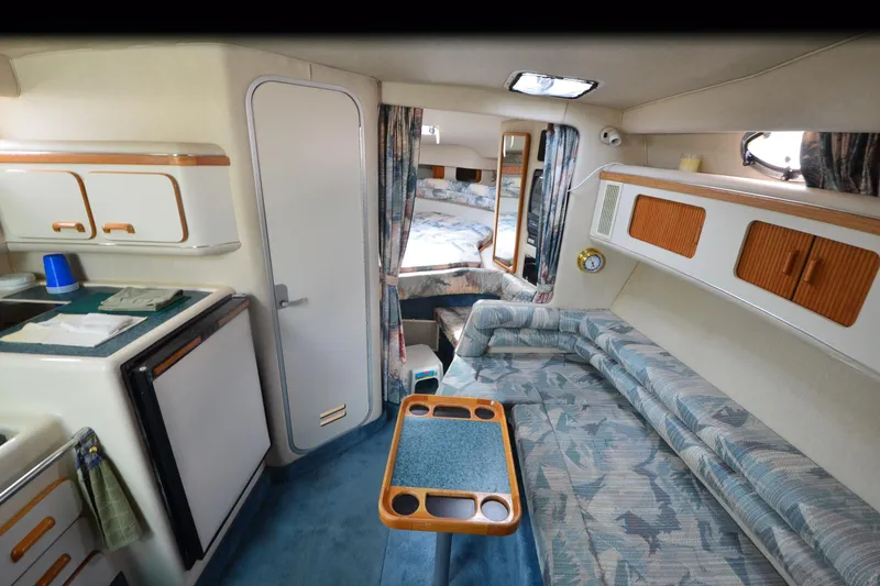 Slide: The Image of 1994 Sea Ray 330 Sundancer cabin interior with kitchenette, seating, and sleeping area. - 20