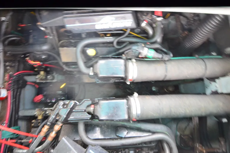 Slide: The Image of Engine compartment of a 1994 Sea Ray 330 Sundancer boat, showing hoses and wiring. - 30