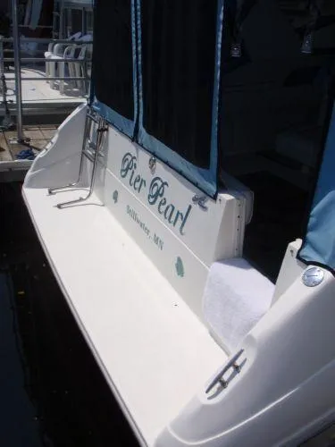 Slide: The Image of 1994 Sea Ray 330 Sundancer docked, featuring "Pier Pearl" name on the stern. - 6