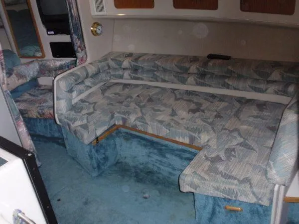 Slide: The Image of Interior of 1994 Sea Ray 330 Sundancer with patterned seating and blue carpet. - 9