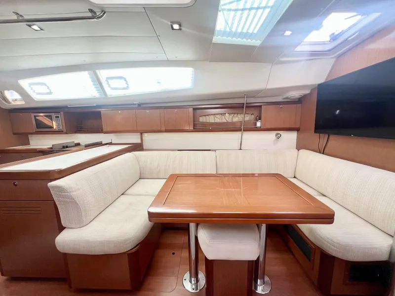 Slide: The Image of Luxurious interior of 2008 Beneteau 46 yacht with elegant seating and dining area. - 11