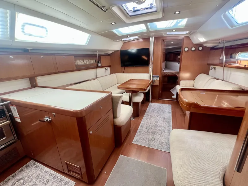 Slide: The Image of Luxurious interior of a 2008 Beneteau 46 yacht with elegant wood finishes and comfortable seating. - 13