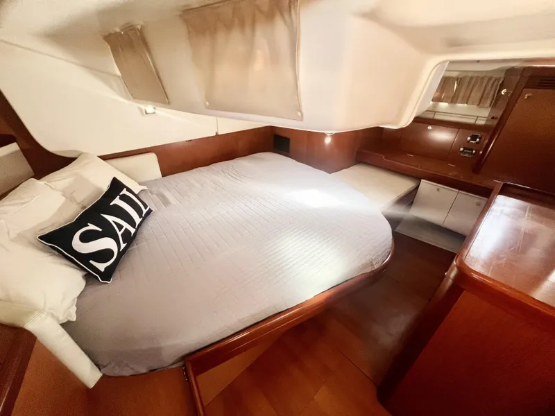 Slide: The Image of Interior cabin of 2008 Beneteau 46 yacht with bed and wooden furnishings. - 16