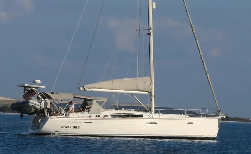 Slide: The Image of 2008 Beneteau 46 sailboat on calm water, side view, with clear sky background. - 2