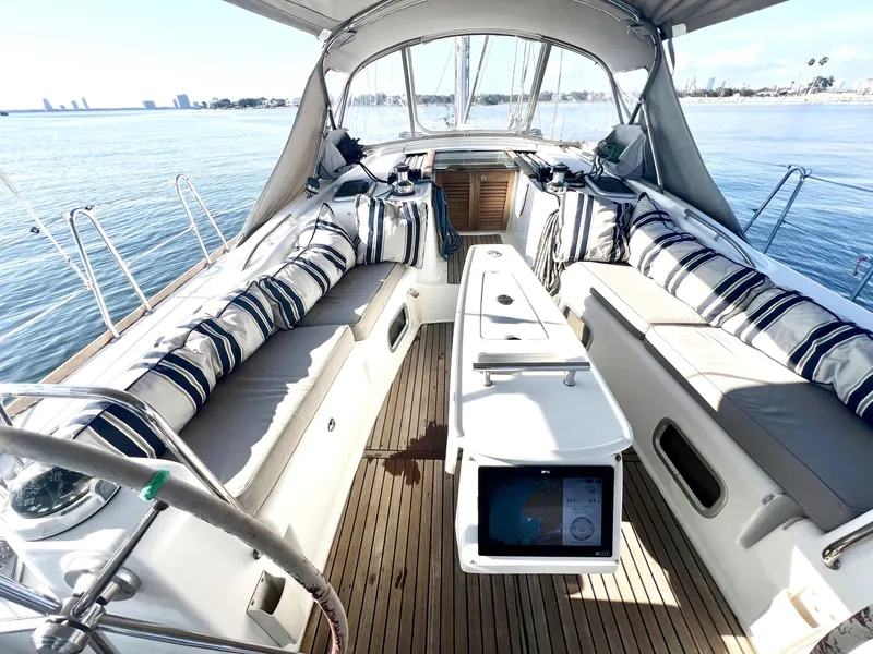Slide: The Image of Spacious 2008 Beneteau 46 sailboat cockpit with striped cushions and ocean view. - 6
