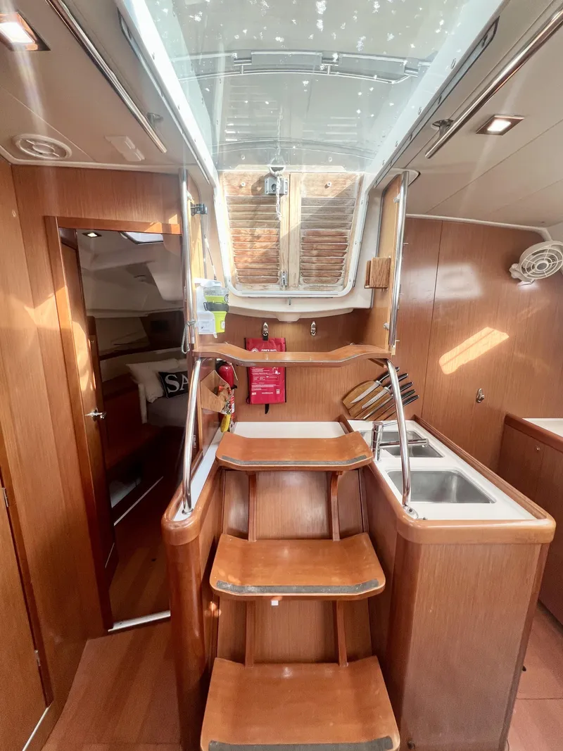 Slide: The Image of Interior of 2008 Beneteau 46 yacht with wooden stairs and modern kitchen area. - 9