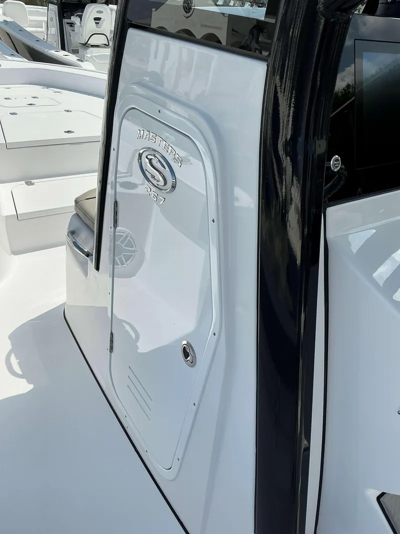 Slide: The Image of 2025 Sportsman 267 Masters boat interior, featuring sleek white and black design elements. - 10