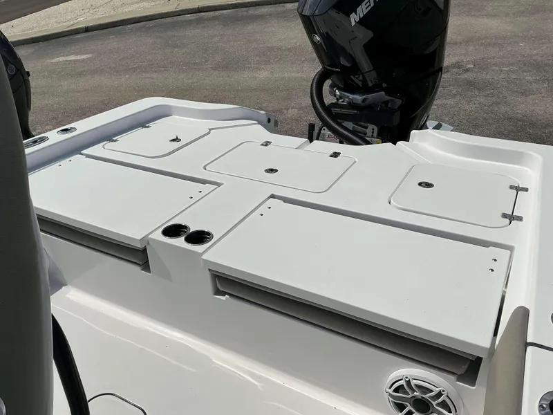 Slide: The Image of 2025 Sportsman 267 Masters boat deck with storage compartments and outboard motor. - 11