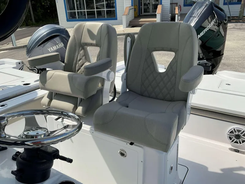 Slide: The Image of 2025 Sportsman 267 Masters boat seats with Yamaha and Mercury engines in background. - 12