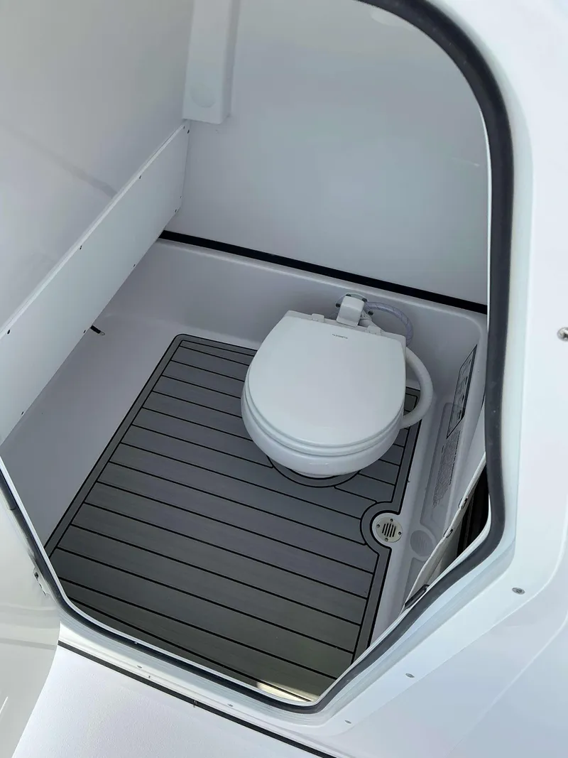 Slide: The Image of 2025 Sportsman 267 Masters boat interior with compact marine toilet. - 18