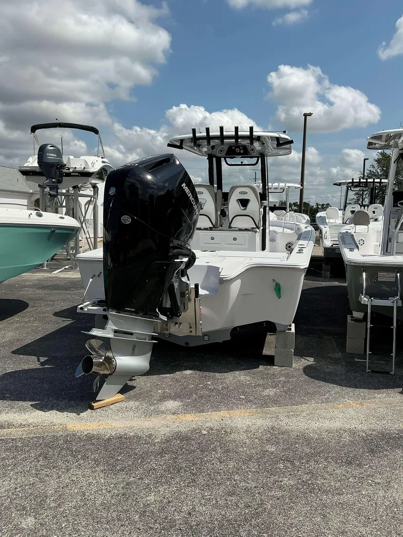 Slide: The Image of 2025 Sportsman 267 Masters boat with powerful outboard motor, parked under a cloudy sky. - 3