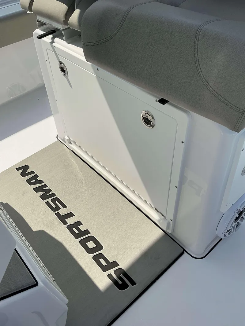 Slide: The Image of 2025 Sportsman 267 Masters boat interior with cushioned seating and branded floor mat. - 4