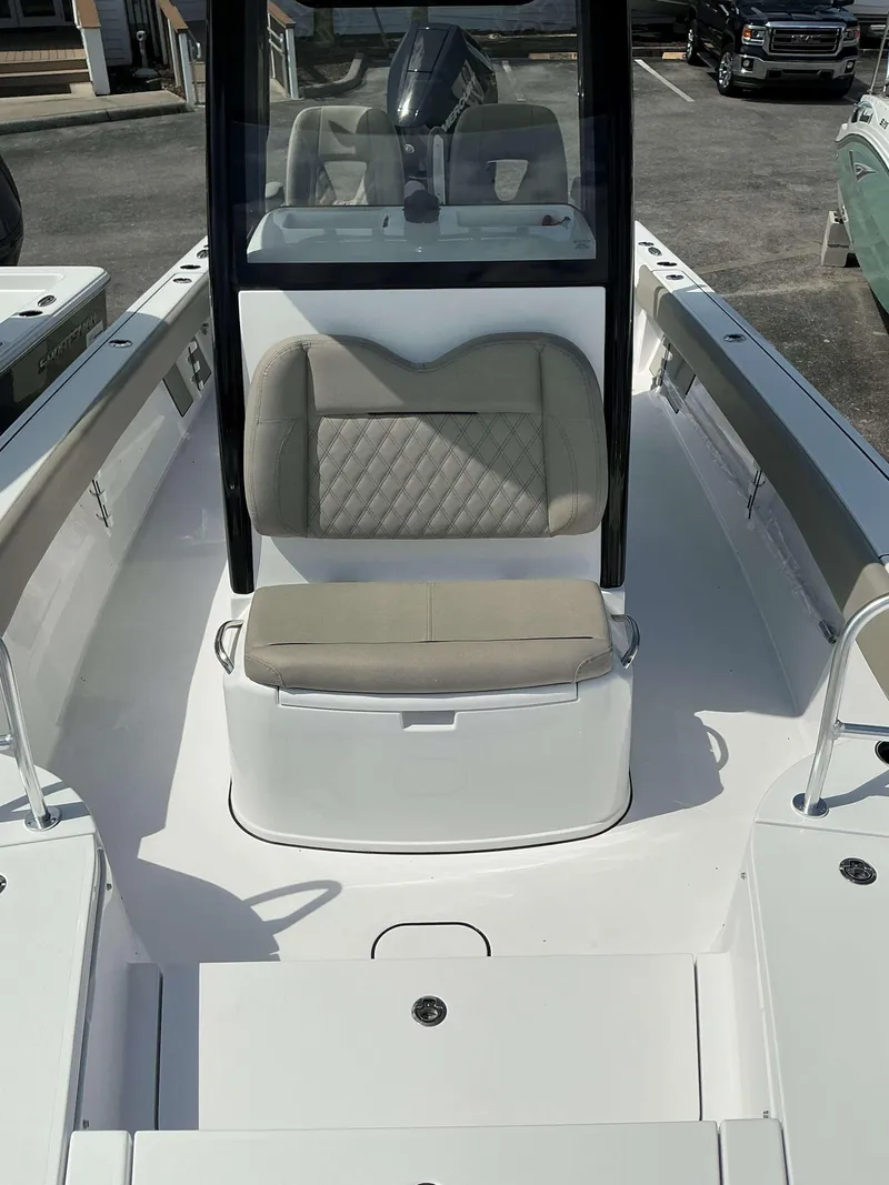 Slide: The Image of 2025 Sportsman 267 Masters boat interior with cushioned seating and console. - 7