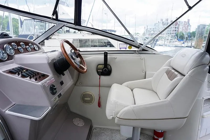 Slide: The Image of Interior of 2000 Regal Commodore 2660 boat with steering wheel and captain's chair. - 12