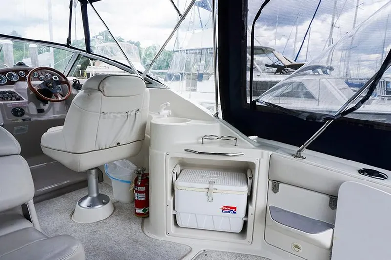 Slide: The Image of Interior of 2000 Regal Commodore 2660 boat with seating, cooler, and steering wheel. - 13