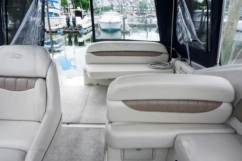 Slide: The Image of Interior of 2000 Regal Commodore 2660 boat with beige seating, docked at marina. - 15