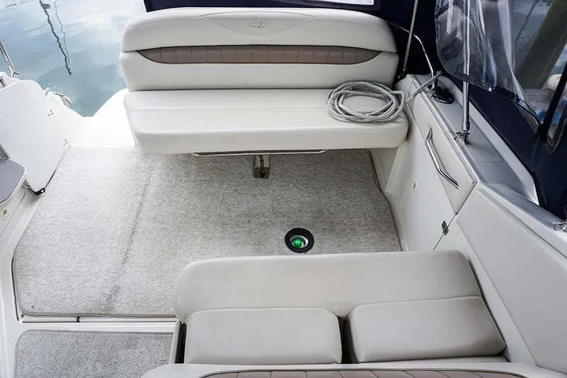 Slide: The Image of Interior of 2000 Regal Commodore 2660 boat with seating and carpeted floor. - 16