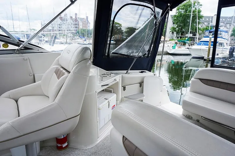 Slide: The Image of Interior of 2000 Regal Commodore 2660 boat with white seating at marina. - 18