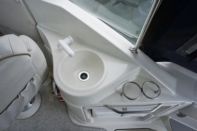 Slide: The Image of 2000 Regal Commodore 2660 boat interior with sink and cup holders. - 19