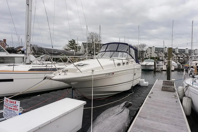 Slide: The Image of 2000 Regal Commodore 2660 boat docked at marina, for sale sign visible. - 2