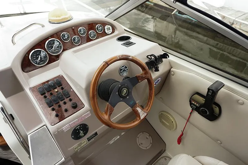 Slide: The Image of Cockpit of 2000 Regal Commodore 2660 boat with wooden steering wheel and control panel. - 20