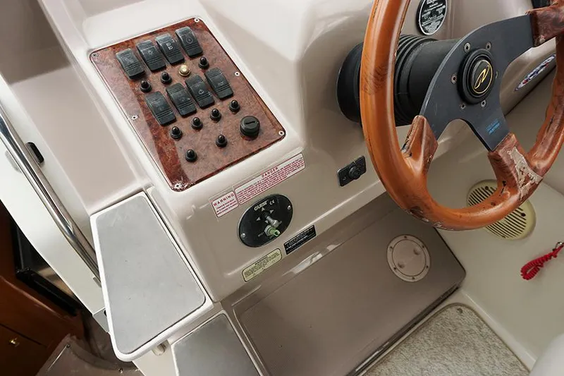 Slide: The Image of Control panel and steering wheel of a 2000 Regal Commodore 2660 boat. - 22