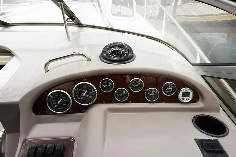 Slide: The Image of Dashboard of a 2000 Regal Commodore 2660 boat with gauges and compass. - 23