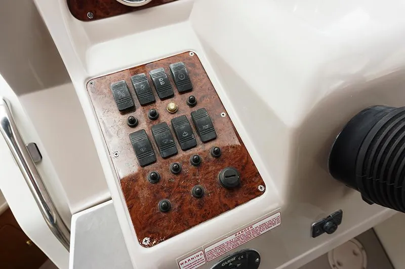 Slide: The Image of Control panel of a 2000 Regal Commodore 2660 boat with switches and dials. - 24