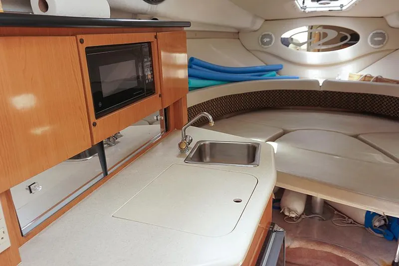 Slide: The Image of Interior of 2000 Regal Commodore 2660 boat with kitchenette and seating area. - 28