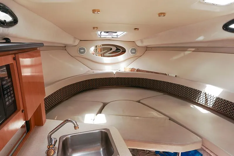 Slide: The Image of Interior of 2000 Regal Commodore 2660 boat with kitchenette and seating area. - 29