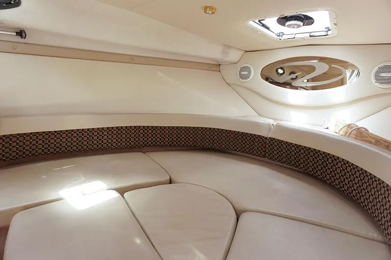 Slide: The Image of Interior of 2000 Regal Commodore 2660 boat, featuring a cozy seating area with elegant design. - 30